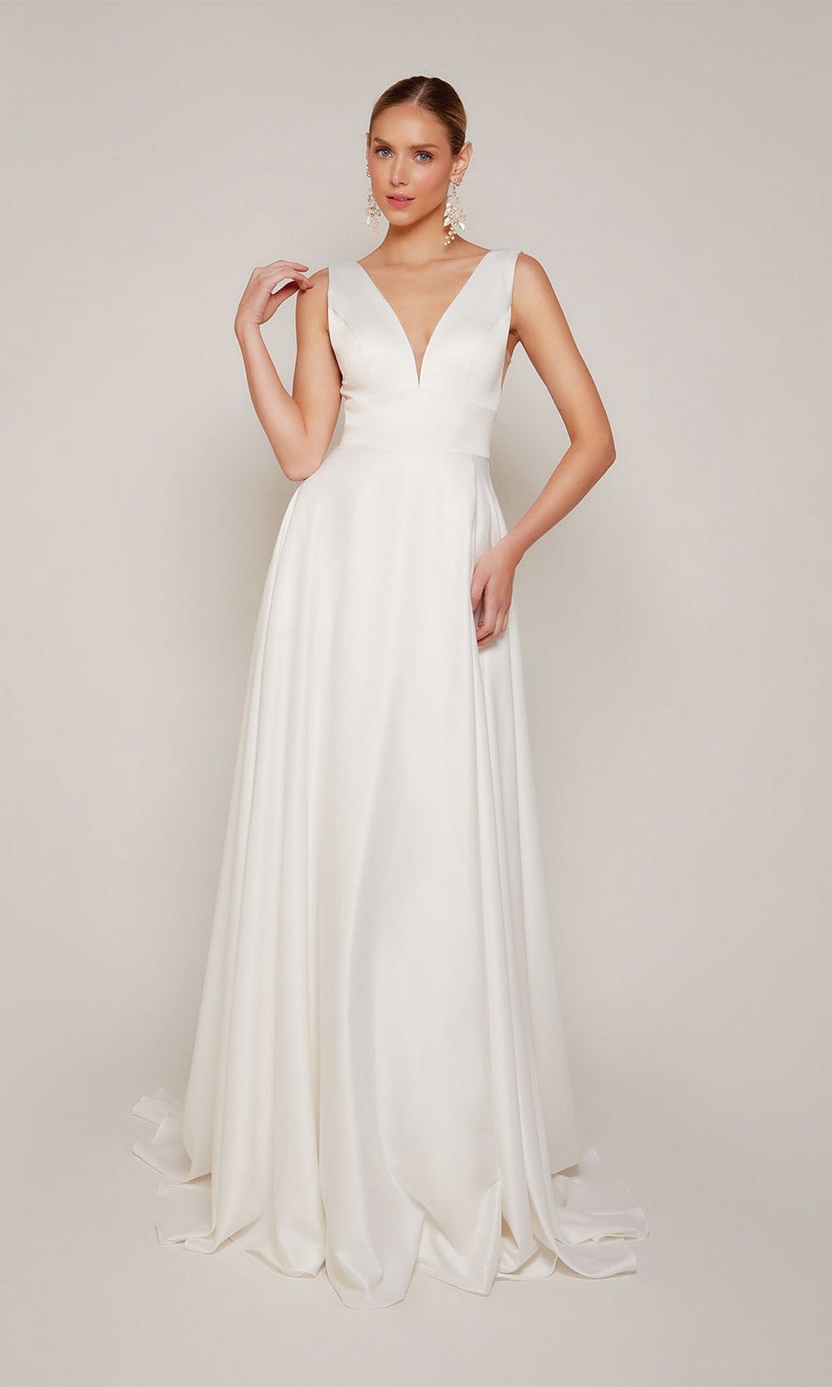 A woman models the Alyce 7096 long formal dress, a sleeveless floor-length satin gown with a deep V-neckline, standing against a plain background.